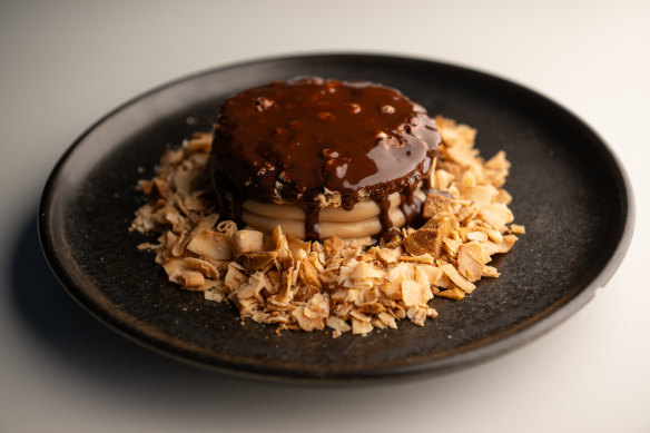 The chocolate-cloaked alfajor is all crisp dacquoise sandwiching dulce de leche and toasted coconut.