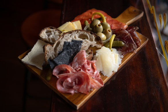 The charcuterie board with three meats and three cheeses.