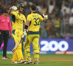 Maxwell and skipper Pat Cummins embrace after the Afghanistan win.