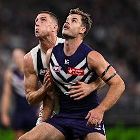 Darcy competes in a ruck contest with Darcy Cameron of the Magpies. 