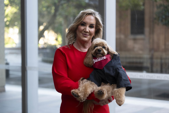 Gina Edwards and Oscar the cavoodle after she won her defamation case against Nine.