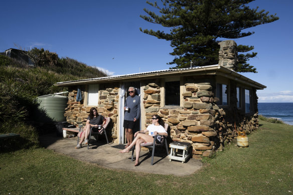 Ken Holloway with his daughters Georgia and Sophie at their shack at Era.