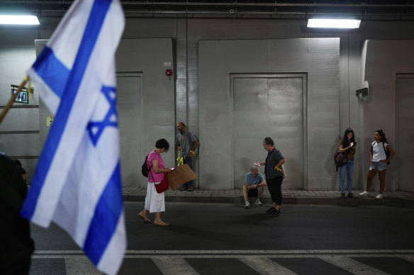 Israelis take cover in an underground car tunnel as a siren warns of incoming rockets.