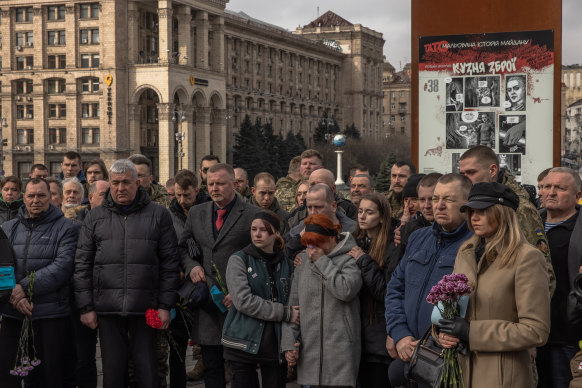 Relatives and friends attend a funeral service of Ukrainian servicemen Oleh Khomiuk and his son Mykyta Khomiuk, who were killed in Bakhmut, at Independence Square in Kyiv on Friday.