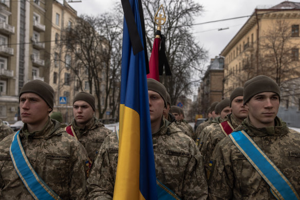 Ukrainian soldiers wait for a funeral ceremony for Ukrainian serviceman Eduard Shtraus, who was killed near Bakhmut.