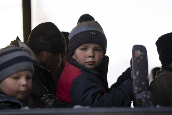 A child looks out of a damaged bus as he and other displaced people arrive at the Ukrainian Red Cross centre in Mykolaiv, southern Ukraine,  last year.