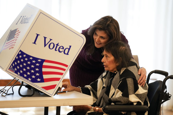 Republican presidential candidate Nikki Haley helps her mother, Raj Kaur Randhawa, to the voting booth on Saturday in Kiawah Island, South Carolina.