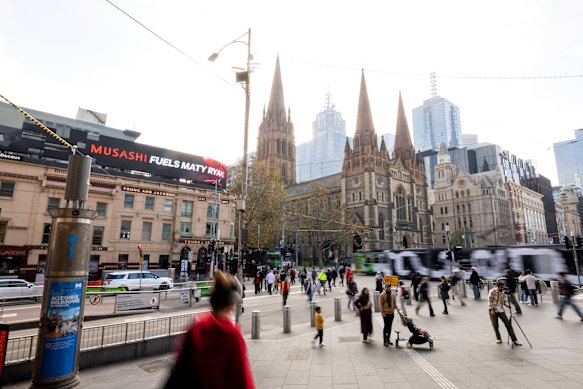 Commuters stream past Young & Jackson pub and St Paul’s Cathedral, which may be impacted by the proposed towers. 