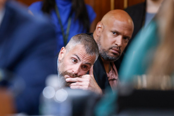 DC police officer Michael Fanone and US Capitol Police officer Harry Dunn, right, watch as the House select committee investigates the January 6 attack on the Capitol.