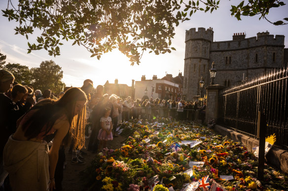 People gather at the gates of Windsor Castle to lay flowers. Queen Elizabeth II will be buried in the King George VI Memorial Chapel, within St George’s chapel in the grounds of Windsor Castle.