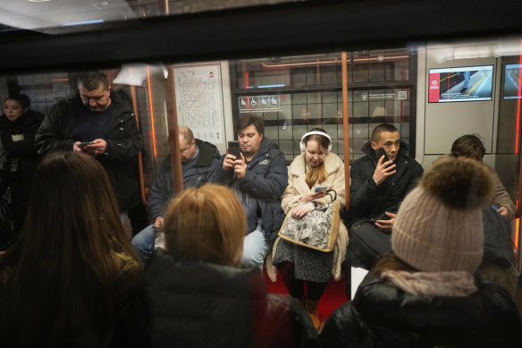 Russians ride the subway in Moscow on Tuesday.