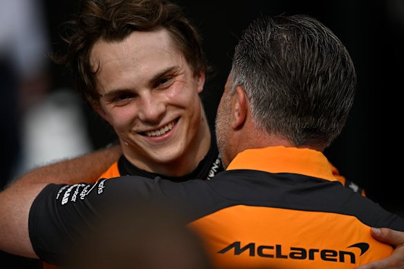 McLaren chief Zak Brown (right) hugs Oscar Piastri after the Hungarian Grand Prix.