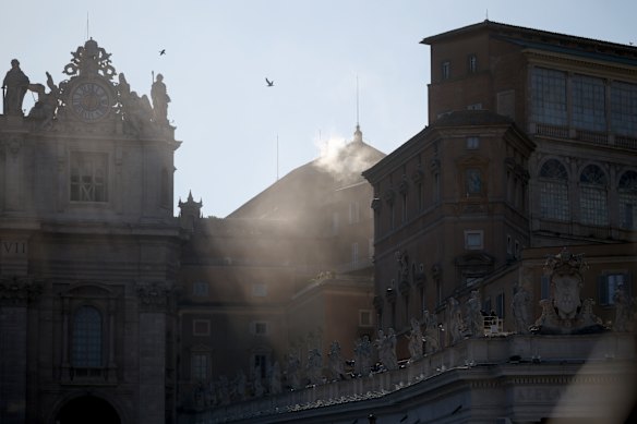 White smoke rises from the chimney on the roof of the Sistine Chapel, indicating a new pope has been elected.