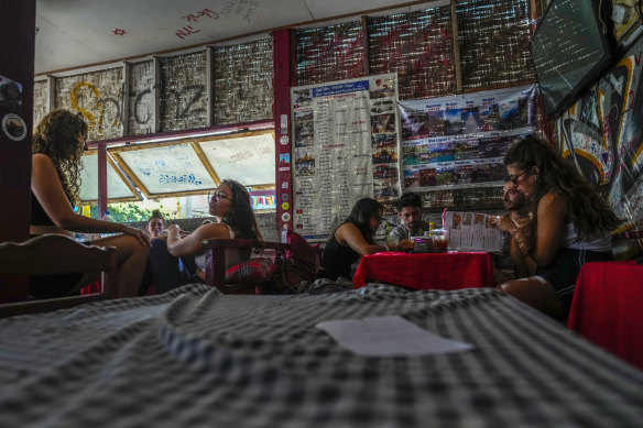 Foreign tourists relax at a bar and restaurant in Vang Vieng.