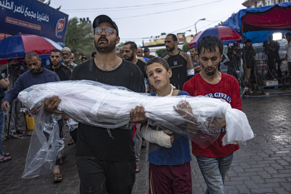Palestinians mourn their relatives killed in the Israeli bombardment of the Gaza Strip, outside the hospital in Khan Younis