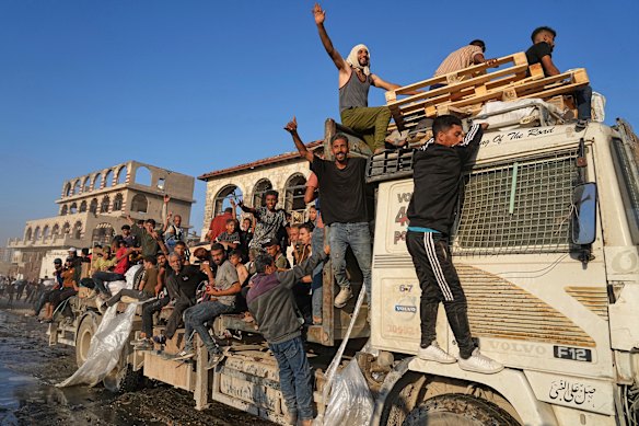 Palestinians travel in a world program truck in North Gaza.