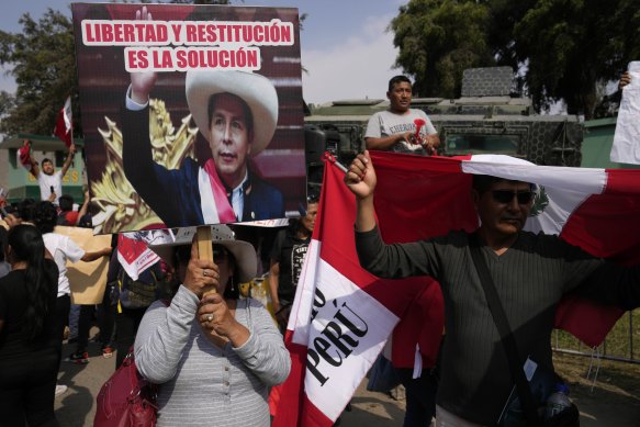 Supporters of ousted president Pedro Castillo gather outside the police base where he is being held on the outskirts of Lima, following his arrest.
