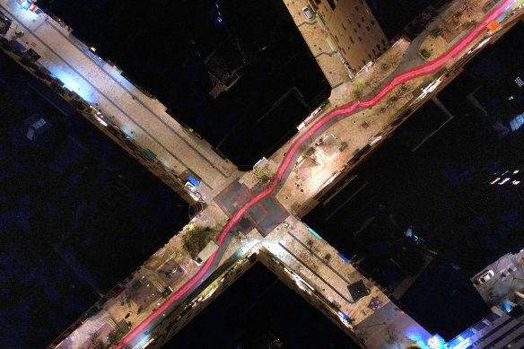 An aerial view of a road, which was painted with red and pink stripes, leading through Jerusalem to Israel’s Sumpreme Court.