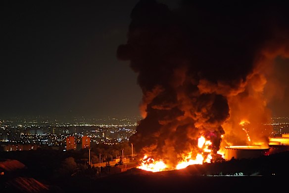Fire and smoke rise into the sky after an Israeli attack on the Shahran oil depot in Tehran.