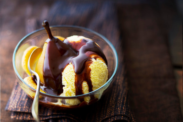 Poire Belle-Hélène, a classic French dessert of vanilla ice cream and poached pears topped with chocolate sauce and whipped cream.