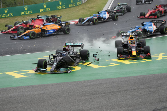 Valtteri Bottas, left, crashes out in Hungary alongside Sergio Perez.