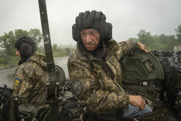 Ukrainian soldiers head towards their forward positions near Bakhmut in the Donetsk region.