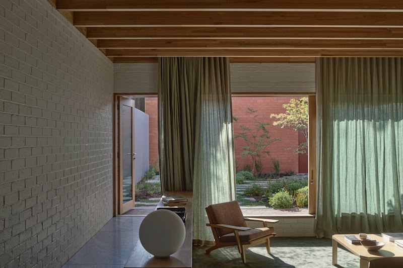 The kitchen and dining areas, with a sunken lounge, overlook the rear courtyard.