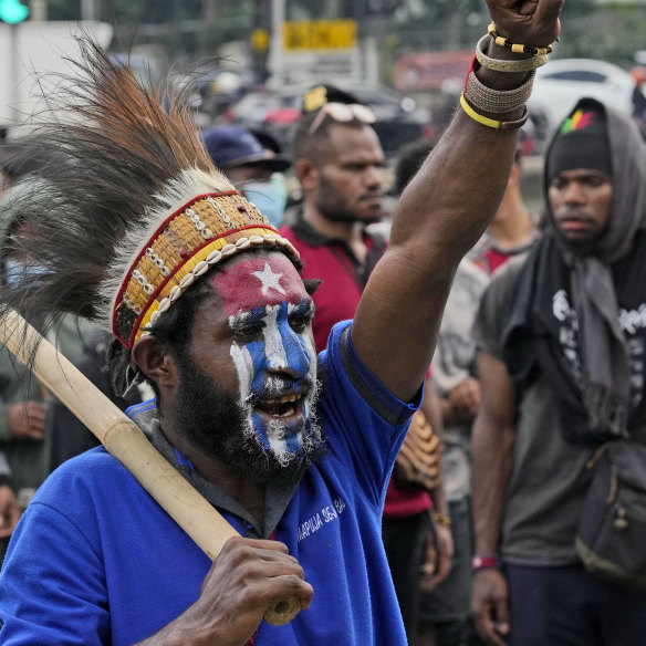 A Papuan activist with face painted in the colors of the separatist ‘Morning Star’ flag 