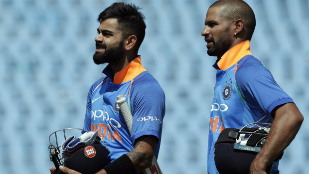Virat Kholi (left) and Shikhar Dhawan leave the field after the win.