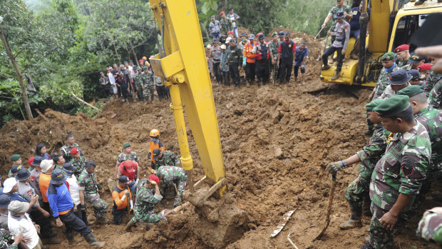 Rescuers recover the body of a victim of a landslide in Cijeruk, West Java, Indonesia, on Tuesday.