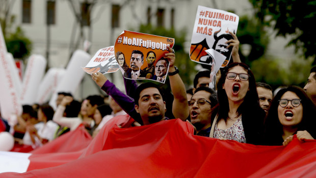 Demonstrators shout slogans against Keiko Fujimori, daughter of jailed former president Alberto Fujimori, blaming her party for corruption charges against President Pedro Pablo Kuczynski in Lima. 