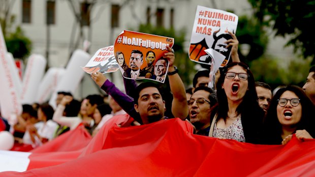 Demonstrators shout slogans against Keiko Fujimori, daughter of jailed former president Alberto Fujimori, blaming her party for corruption charges against President Pedro Pablo Kuczynski in Lima. 