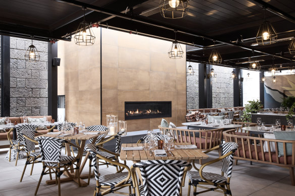 The indoor-outdoor area at North &amp; Common has a retractable roof and fire for cooler weather.