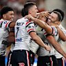 The Roosters celebrate a try.