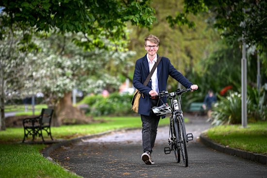Greens candidate for Hawthorn Nick Savage and the Giant bicycle he converted to electric.