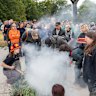 People participate in a smoking ceremony at a dawn service in Melbourne this morning.