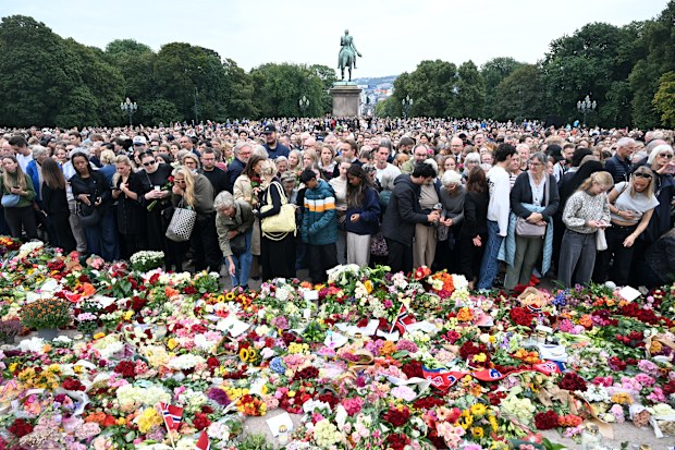 People gather at the Royal Palace Square to pay their respect to King Harald V of Norway on August 28, 2026 in Oslo, Norway