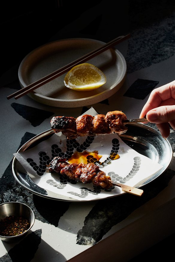 Chicken thigh, king prawn and miso salmon skewers are cooked on a hibachi grill. 