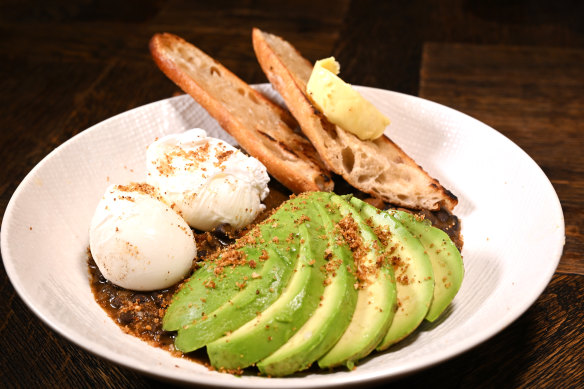 Avocado on black beans, with poached eggs, smoked chilli and breadcrumbs.