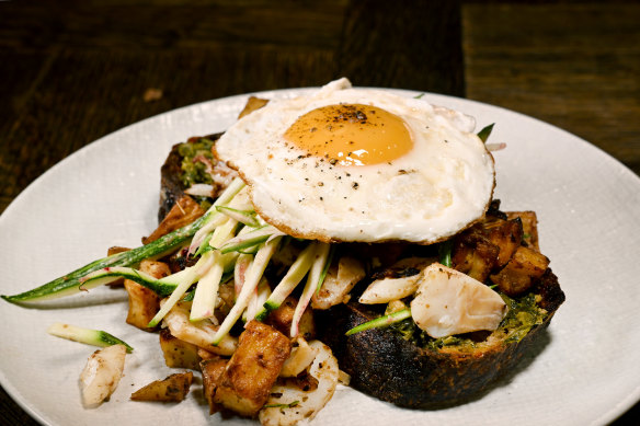 Salt cod and potato hash with zucchini, salsa verde, sunny side eggs and charred sourdough.