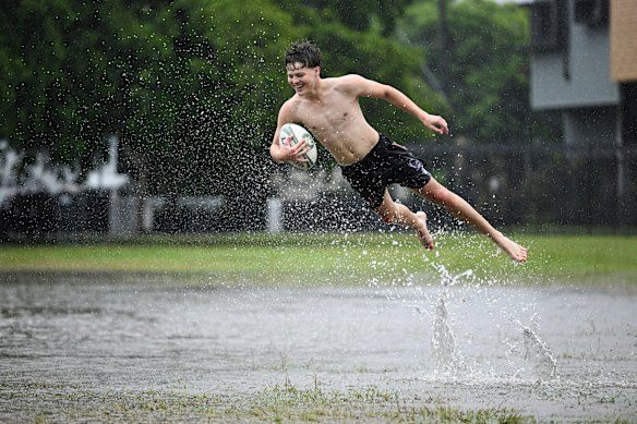 Boys make the most of a flooded park in Rosalie.