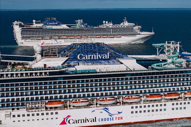 Carnival Adventure and Carnival Encounter sailing side by side.