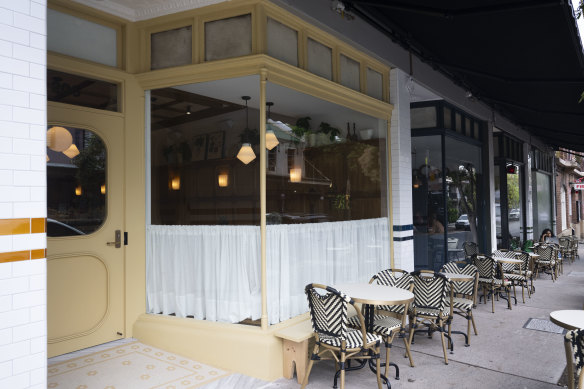Flora, with the buttercup-yellow facade, also has outdoor tables.