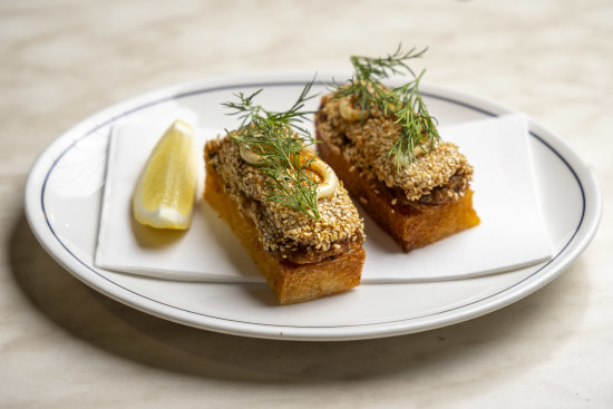 Sesame-encrusted crab toast is a play on Cantonese prawn toast.