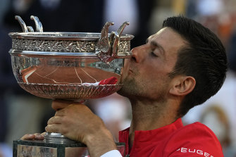Serbian Novak Djokovic gets his hands – and his lips – on the trophy.