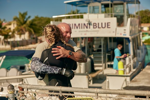 Dive expert and shark attack survivor Paul de Gelder hugs Ariarne Titmus in Shark! 