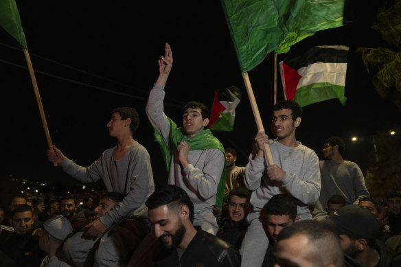 Former Palestinian prisoners who were released by Israeli authorities fly Palestinian and Hamas flags.