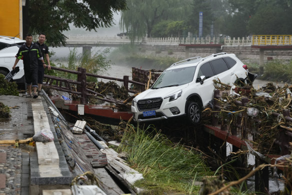 A vehicle washed away by floodwaters in the Mentougou district on the outskirts of Beijing on Tuesday.