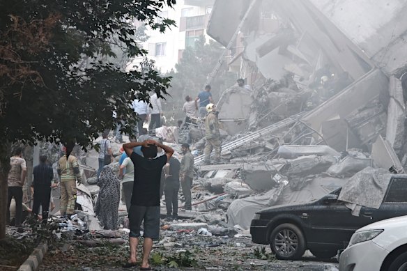 People are viewing damage to buildings in Nobonad Square after Israeli air on Friday in Tehran.
