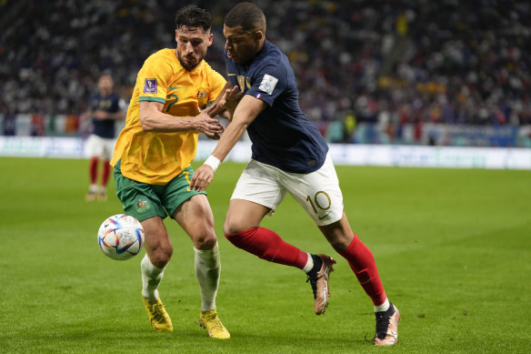 Mathew Leckie tangles with French superstar Kylian Mbappe at last year’s World Cup.